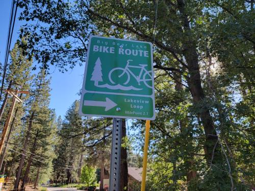 a green bike route sign on the side of a street at Four Seasons Getaway-Private Hot Spa with Pine Tree Views-Walk to Village and Pineknot Trailhead-Plus King Bed! in Big Bear Lake