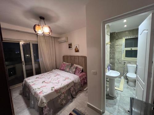 a bedroom with a bed and a sink and a toilet at فيلا مميزه جدا في الساحل الشمالي ستيلا هايتس Stella Heights - Sidi Abd El-Rahman villa type M in El Alamein