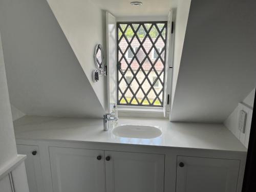 a bathroom with a sink and a window at Alms Houses in Kinsale