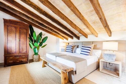 1 dormitorio con cama y techo de madera en Cas Misser en Algaida