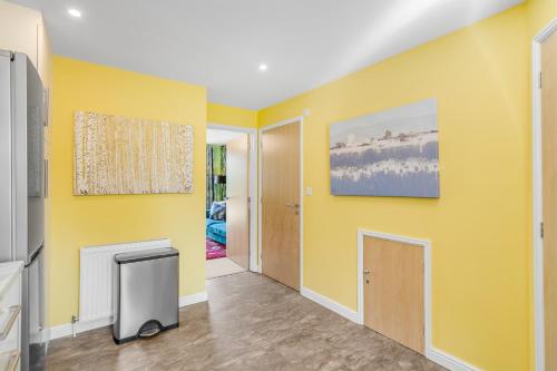 a living room with yellow walls and a tv at #034 Saunders Rest in Norwich