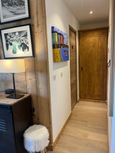a hallway with a door and a lamp and a floor at Arc 1950 Ski in Ski out and Spa- Newly refurbished 153 Sources De Marie- 2 bedroom , 2 bathroom-Sleeps 4-6, Mont Blanc view from every window, Free WiFi in Arc 1950