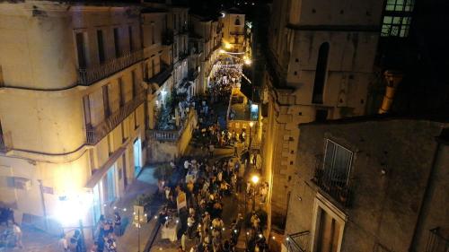 a crowd of people walking down a street at night at Dimora 7 fontane in Paola