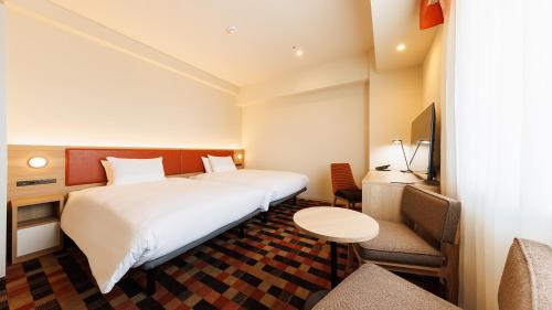 Postel nebo postele na pokoji v ubytování JR-East Hotel Mets Koenji