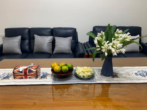 a table with two bowls of fruit and a vase of flowers at 芯之所嚮 in Hualien City