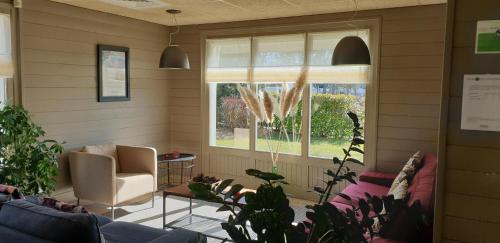 a living room with a couch and a window at Hotel Campanile Besançon Nord Ecole Valentin in Besançon