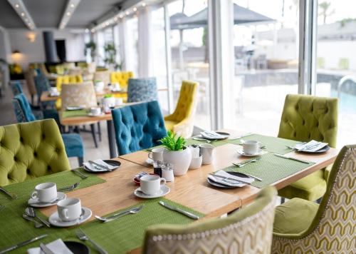 a dining room with a wooden table and chairs at Peninsula All Suite Hotel by Dream Resorts in Cape Town