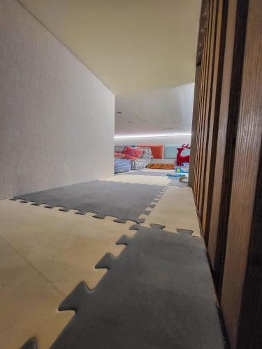 a room with a wall with a shadow on the floor at LIKE HOME 2 Sauna,Jacuzzi & Spa in Świdnica