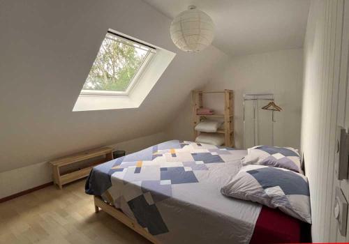 a bedroom with a bed and a window at La Fantasia in Saint-Sylvain-dʼAnjou