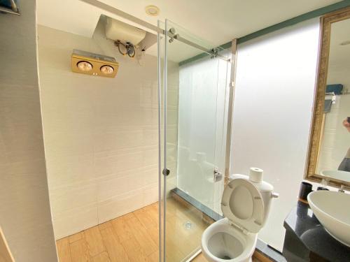 a bathroom with a shower and a toilet and a sink at Libré Homestay in Hanoi