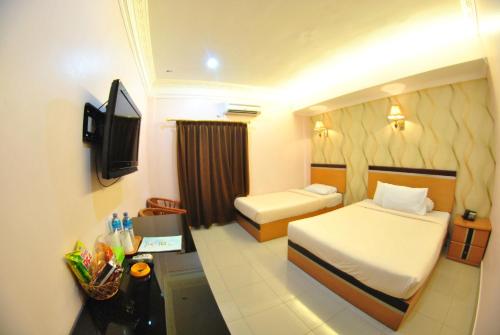 Tempat tidur dalam kamar di Hotel Panorama