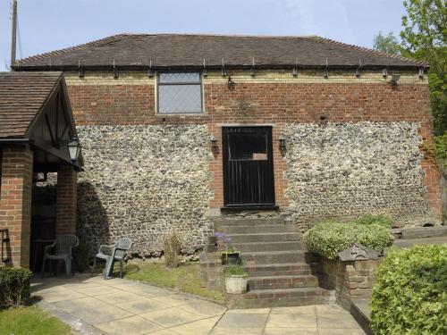 a brick house with a door and stairs in front at Lower Bell in Aylesford