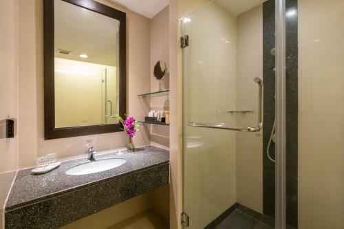 a bathroom with a sink and a shower at Kantary House Hotel, Bangkok in Bangkok