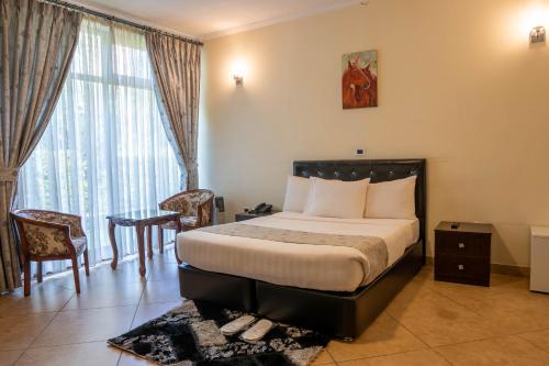 a hotel room with a bed and a window at Yaya Africa Athletics Village in Sululta