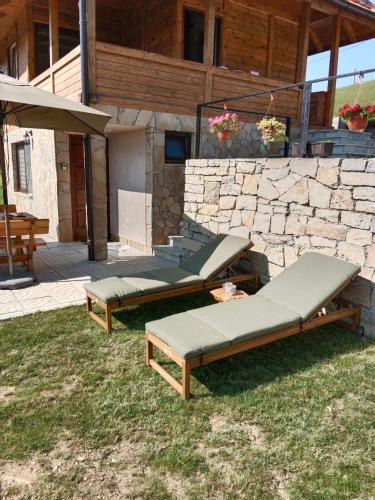 a group of beds sitting on the grass in front of a building at Zaovinska Panorama I in Bajina Bašta