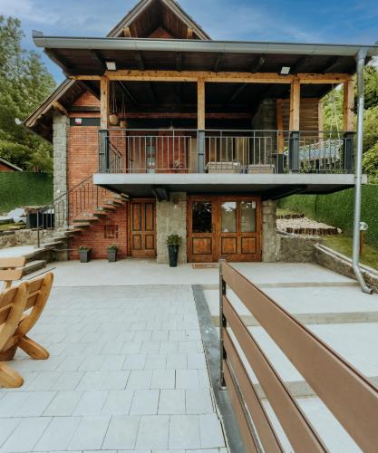 a house with a deck and a balcony at Vista Lago,Orahovica jezero in Duzluk