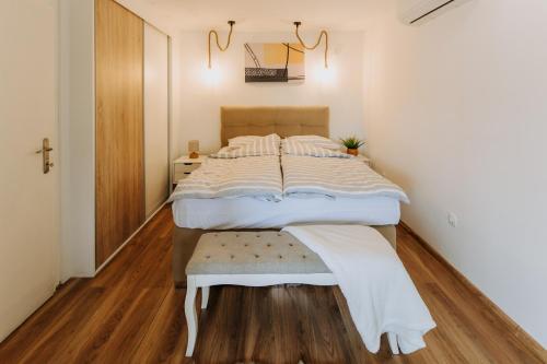 a bedroom with a large bed and a wooden floor at Vista Lago,Orahovica jezero in Duzluk