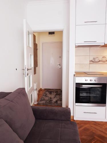 a living room with a couch and a kitchen at Emili apartment in Belgrade
