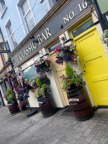 a restaurant with flower pots in front of a store at No 16 Main Accommodation in Buncrana