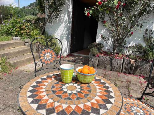 a table with two bowls of oranges on top at Charming alps apartment perfect for walk/cycle/ski in Eschenbach