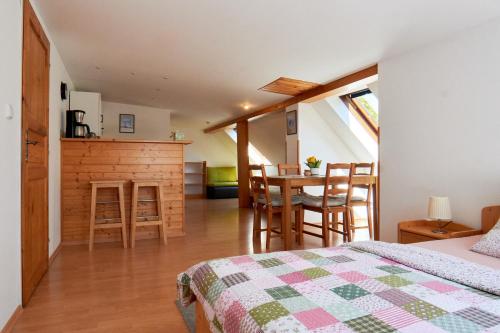 a bedroom with a bed and a table and chairs at Chata Harmonie in Bedřichov