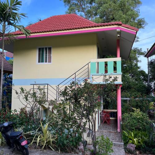 a house with a red roof and a balcony at Oceanview Bungalows by EAT in Karon Beach