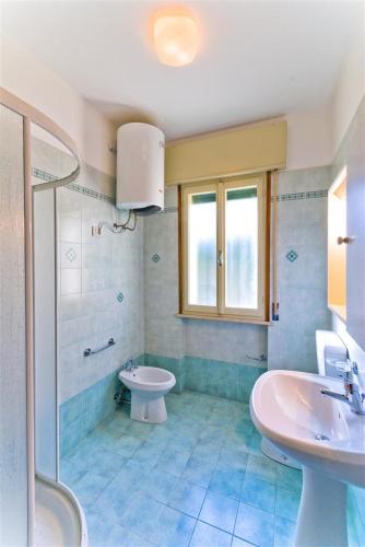 a bathroom with a sink and a toilet and a shower at Luca in Bibione
