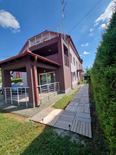 a building with a wooden walkway in front of it at KFN Concept One in Zagreb