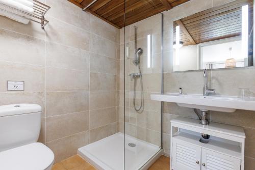 a bathroom with a shower and a toilet and a sink at Villa Sainte Anne in Porquerolles