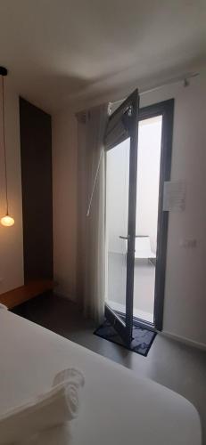 a room with a large window and a door at Patio 101 "Exclusive" in San Vito lo Capo