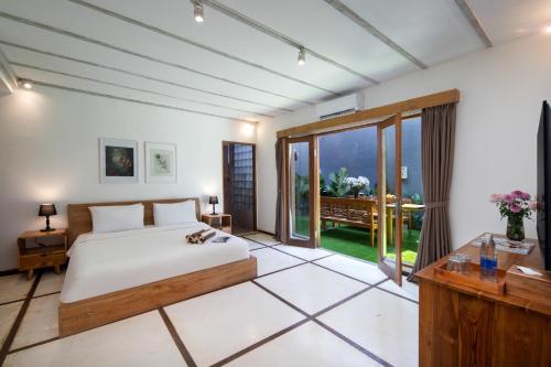 a bedroom with a bed and a large window at BIG & PRIVATE 9 BED, 9 BATH, Viola Villa, POOL, Best Location in Seminyak