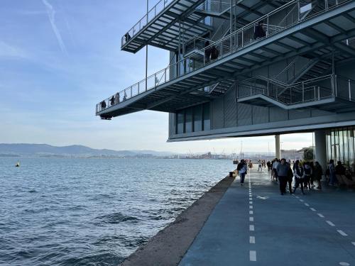 a group of people walking on a pier next to the water at Apartamento con encanto 2 hab céntrico-ayuntamiento in Santander