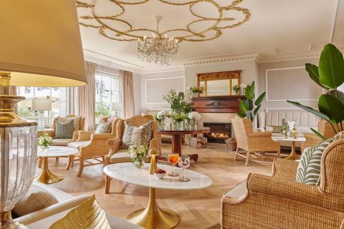 a living room with furniture and a chandelier at Killarney Royal Hotel in Killarney
