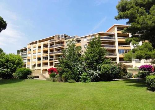 an apartment building with a green lawn in front of it at Hyères : Appartement T2 au Port St Pierre in Hyères