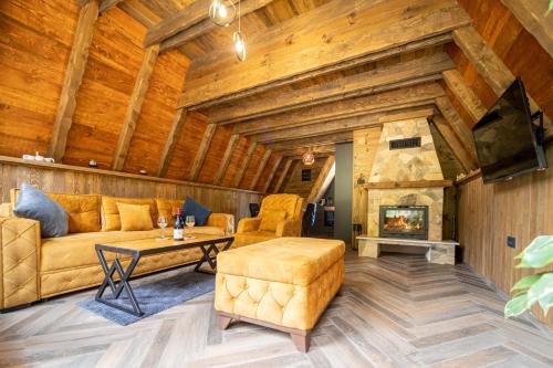 a living room with a couch and a fireplace at Woodland Brezna in Plužine