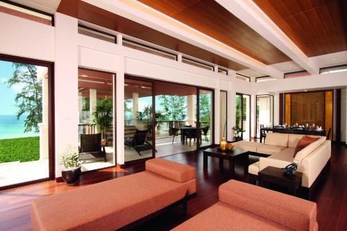 a living room with a couch and a table at Mövenpick Resort Bangtao Beach Phuket in Bang Tao Beach