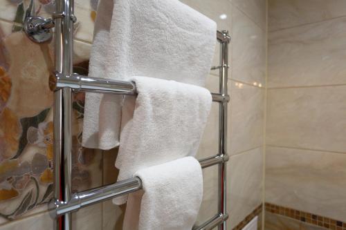 a bathroom with white towels on a towel rack at Europa Hotel in Irkutsk