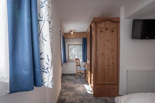 a room with a bedroom with a bed and a table at Huber Apartments in Kappl
