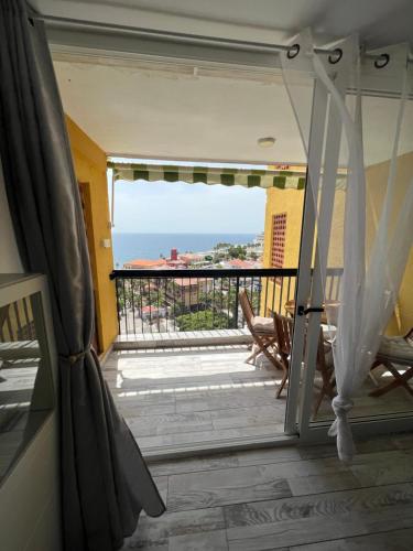 a door to a balcony with a view of the ocean at Lookout Point Tenerife Holiday Apartment Las Americas in Playa Fañabe
