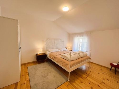 a bedroom with a bed in a room with a window at Zamaria Apartments in Vis