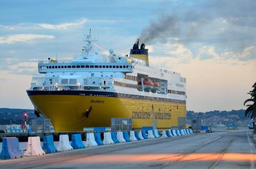 a large cruise ship is docked at a dock at Grand Hôtel Dauphiné Toulon, Boutique Hôtel & Suites in Toulon