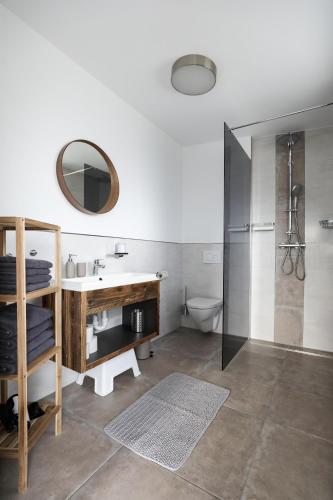 a bathroom with a sink and a toilet and a mirror at Ferienwohnung Dohr in Kundl