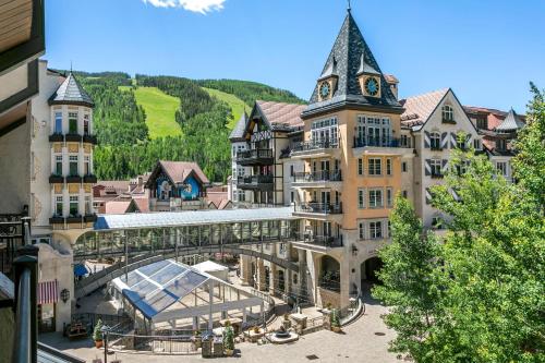 a building with a clock tower on top of it at Lift House Lodge, Downtown Lionshead Remodeled Studio Condo in Vail