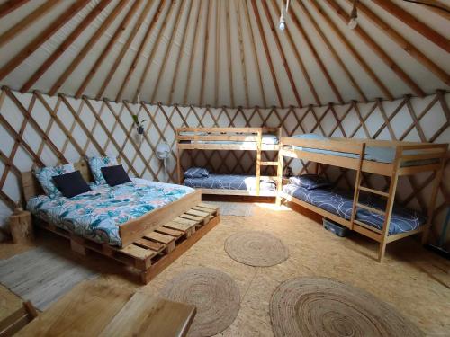 a room with two beds in a yurt at la Yourte des Bibis in Fréland