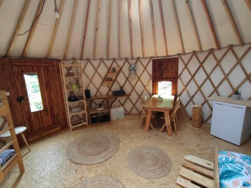 an interior view of a yurt with a table and chairs at la Yourte des Bibis in Fréland