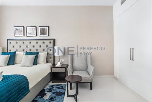 a bedroom with a bed and a chair at Posh Studio - Comfort and Peace - Bills Included in Dubai