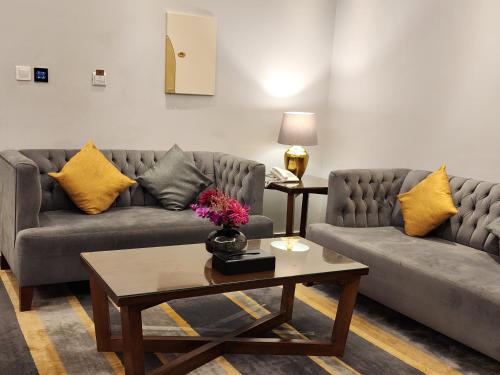a living room with two couches and a coffee table at دار ود للشقق المخدومة Dar Wed in Jeddah