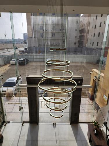 a group of circular chairs in a room with a window at دار ود للشقق المخدومة Dar Wed in Jeddah