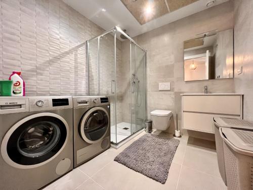 a bathroom with a washing machine and a shower at Cape villa in Cabo de Roig by Perfectly Rentals in Orihuela