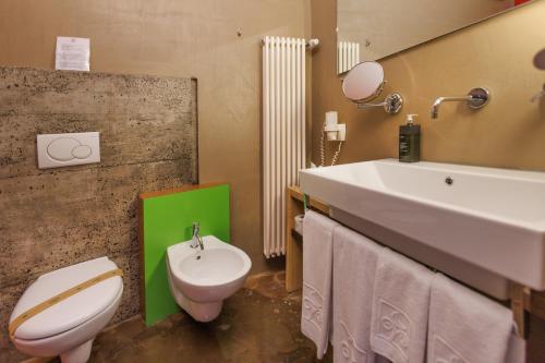 a bathroom with a white toilet and a sink at Ambienthotel PrimaLuna 3S in Malcesine